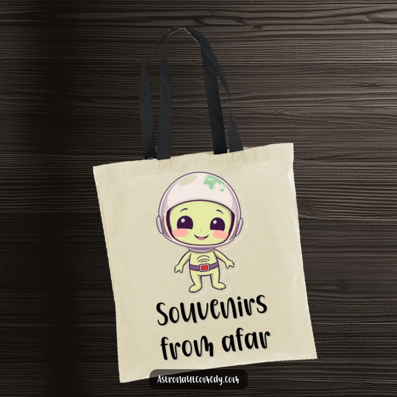 Funny tote bag with a smiling alien in a helmet looking down at planet Earth with a wondrous expression.